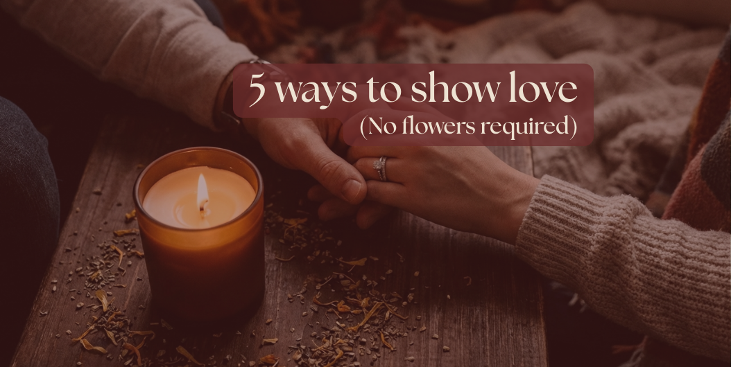 Two people holding hands near lit candle - showing love and intimacy in quiet moment at home