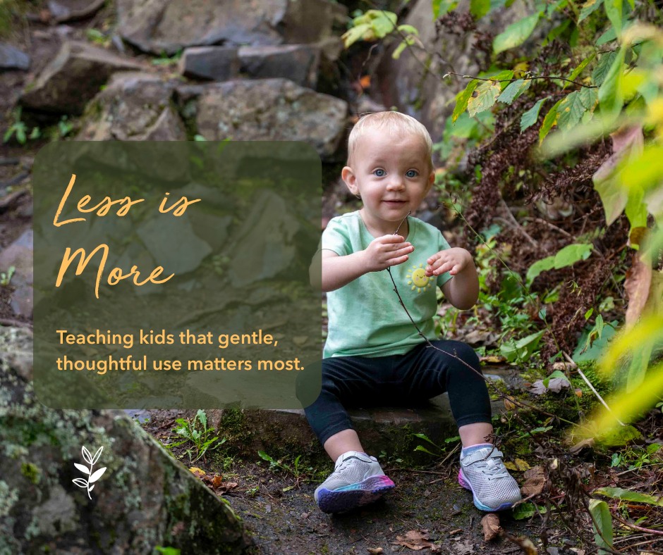 A young child sitting on a rocky path in a natural setting, smiling and holding a small object, with greenery around and text overlay promoting thoughtful use.