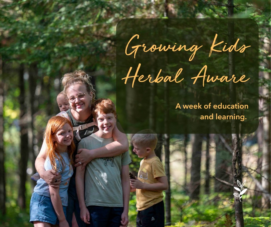 A smiling woman with glasses and four children in a forest setting, promoting 'Growing Kids Herbal Aware' program focused on education and learning.