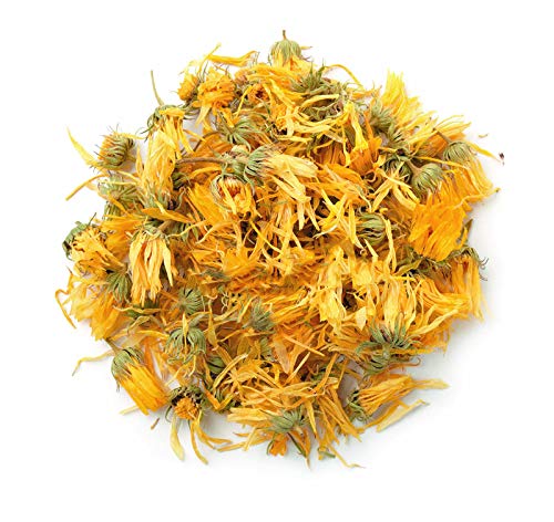 Dried marigold petals scattered on a white background.