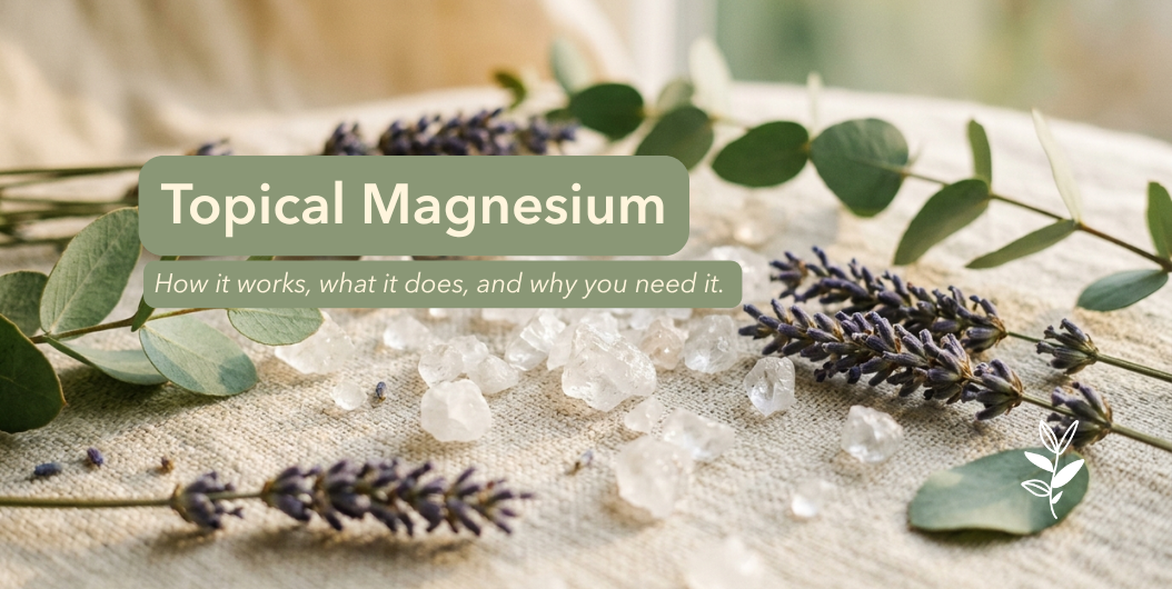 Magnesium chloride crystals scattered on natural linen fabric with dried lavender sprigs and eucalyptus leaves, hero image for Juniper Apothecary's complete guide to topical magnesium benefits and uses